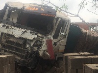 The truck ran into the house after crashing into a sprinter bus
