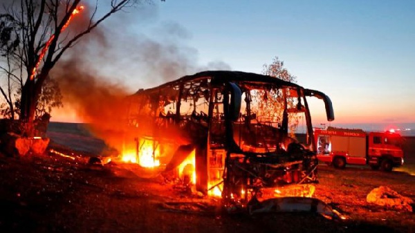 An empty bus in a kibbutz was set ablaze after being hit and an Israeli seriously wounded