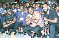 Fuse ODG (left) with some of the kids and other officials