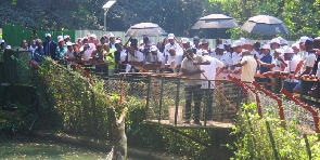 CSPOC delegates are seen observing as a worker feeds a crocodile during a tour