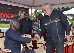 Former Presidents John Agyekum Kufuor (l) and Jerry John Rawlings (r) in a handshake