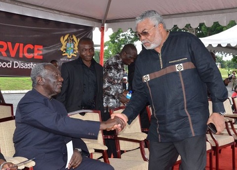 Former President Rawlings (r) in a handshake with Former President Kufuor (l)
