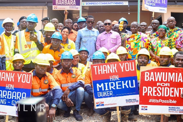 George Mireku Duker and the Western Regional minister in a photo with the workers