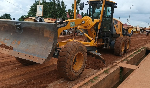 An exacavator is seen working on a road