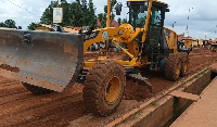 An exacavator is seen working on a road