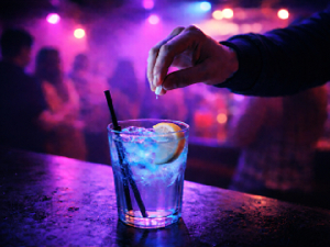 A file photo of someone placing a drug in a drink at a bar