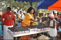 Madam Sawyer, clad in a colorful Christmas dress, distributed gifts, food and drinks to the childr