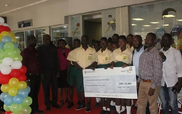 Christian Methodist students and officials show off the Cheque for Ghc3000