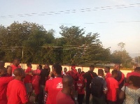 Residents clad in red hit the streets to put pressure on government to complete the footbridges