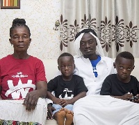 Lil Win poses with his two sons and mum