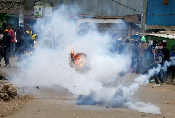 A tear gas canister lobbed by riot police explodes as some Kenyans protests against tax hikes