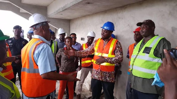 Minister of Youth and Sports interacting with some contractors when he paid a visit to the facility
