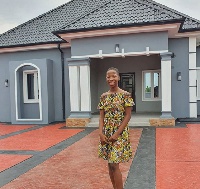 Young comedienne, Emmanuella in front of the house