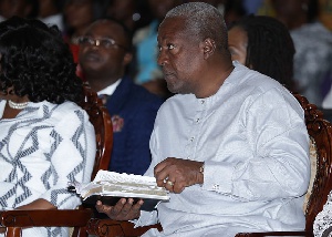 President John Mahama flipping through his Bible