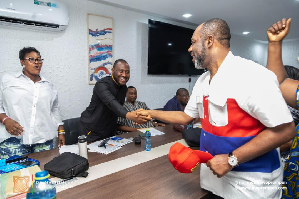 NAPO in a handshake with one of the executives at the vetting