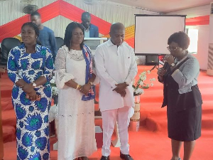 Stephen Ntim (in white) receiving prayers with Akosua Manu (in African print)