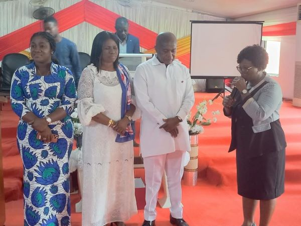 Stephen Ntim (in white) receiving prayers with Akosua Manu (in African print)