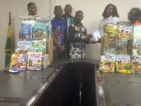 Madam Evelyn Amponsah (right) presenting the books to Mr. James K. Naabah
