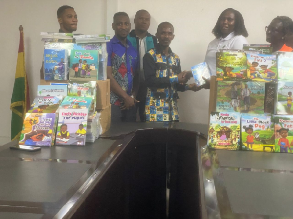 Madam Evelyn Amponsah (right) presenting the books to Mr. James K. Naabah