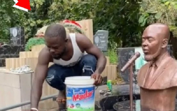 Kofi Boakye bathing his brother's tomb