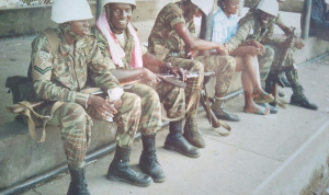Gambian soldiers object to having their photos taken as they leave a ferry in Banjul Gambian soldiers object to having their photos taken as they leave a ferry in Banjul