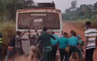 Image of Police, Immigration officers pushing EC truck