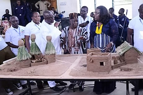 Nana Oye Lithur inspects a miniature community with some dignitaries