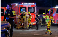 Emergency personnel gather after a car crashed into the crowd at Tiergarten park