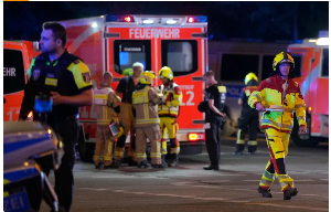 Emergency personnel gather after a car crashed into the crowd at Tiergarten park