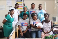 The AirtelTigo team with nurses and a new mother at La General Hospital in Accra