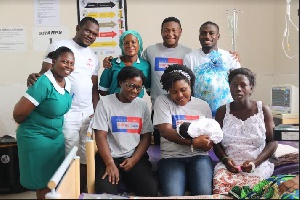The AirtelTigo team with nurses and a new mother at La General Hospital in Accra