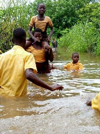 Students crossing river to school