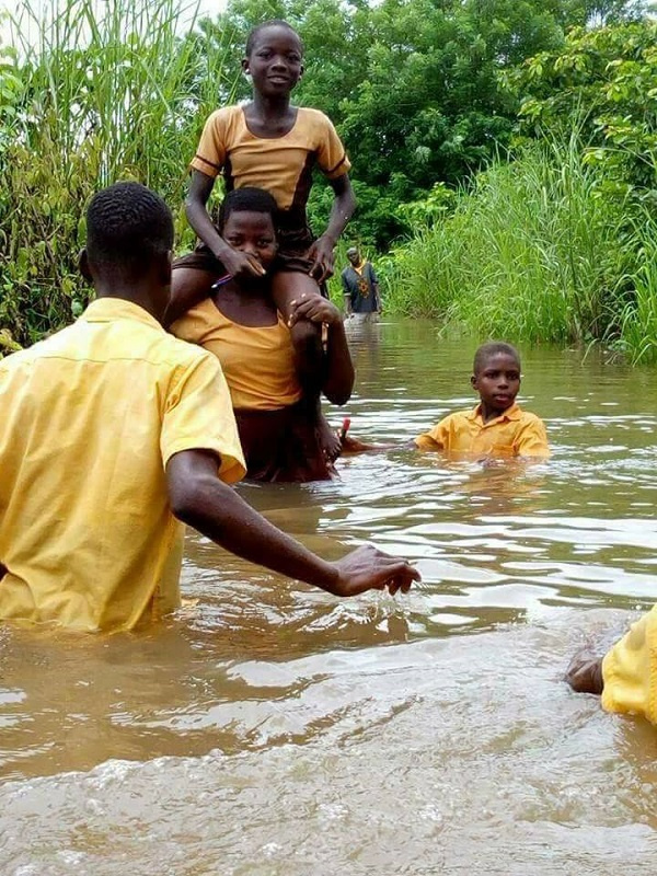Students crossing river to school