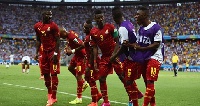 Asamoah Gyan of Ghana celebrates with his teammates scoring
