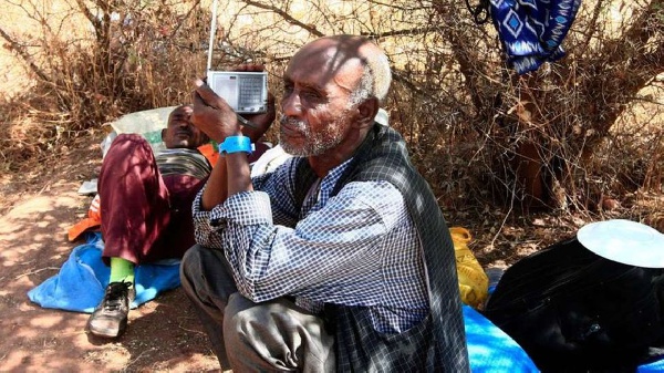 An Ethiopian refugee who fled fighting in Tigray province listens to a radio at the Um Rakuba camp