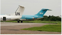 A Wimbi Diri aircraft sits on the runway behind a UN's plane at the airport in Kisangani, Congo