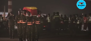 Militaryofficers with the coffin draped in Ghana flowers