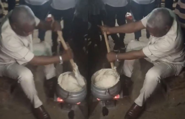 Ledzokuku MP, Benjamin Narteh Ayiku preparing banku for a constituent