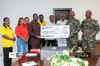 Bernard Oduro Takyi presenting the cheque to Air Vice Marshal (AVM) Joshua Mensah Larkai