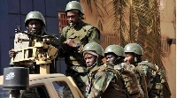 Malian troops patrol outside the Radisson Blu hotel in Bamako