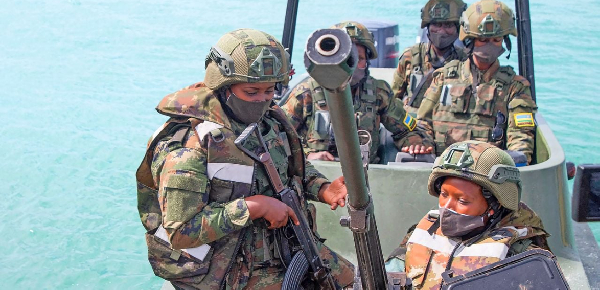 Rwandan soldiers sit on a boat in the port city of Mocimboa da Praia, northern Mozambique