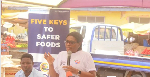 Maureen Lartey (with mic) addressing traders at the Mallam Atta Market in Accra