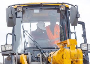 Mahama drives an excavator at the commissioning of Agbogbloshie waste evacuation exercise