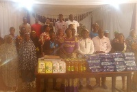 Beneficiaries pose with members of the Foundation after the donation
