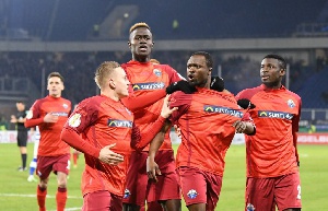 Bernard Tekpetey celebrates with team mates after scoring in the match