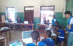 A cross-section of students being taught how to use the computer
