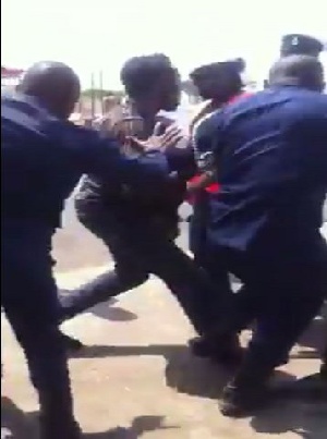 Police officers beating the taxi driver