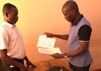 Haruna Iddrisu (Right) Returning his nomination paper to EC Official (Left)