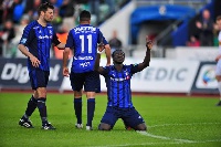 Ernest Asante kneels to celebrate a goal