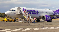 Passengers disembark a Bonza plane in December 2023